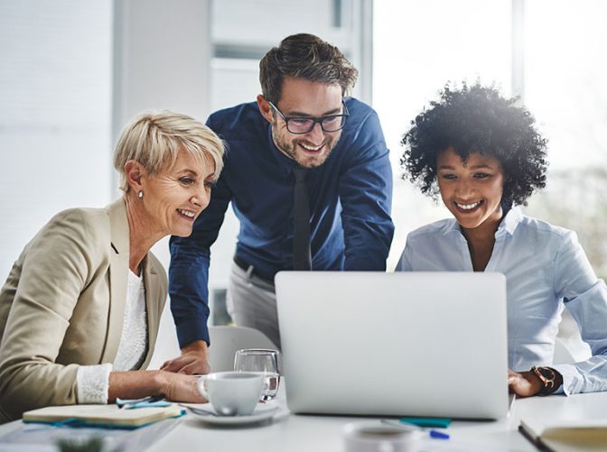 CX managemenet has a meeting showing their CX metrics on their laptop